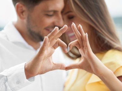 Beautiful,Couple,In,Love,Making,Heart,With,Hands.,Happy,Smiling